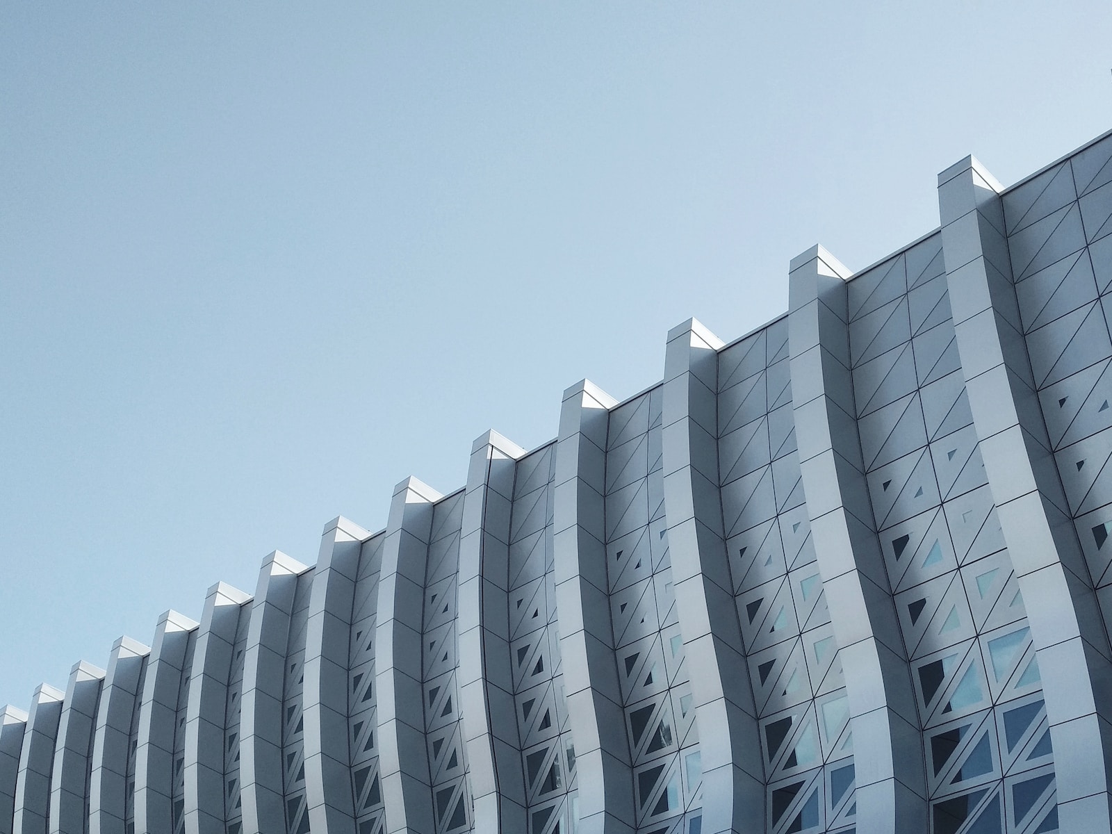 architectural photography of a gray concrete building under a clear sky